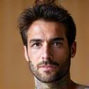 Portrait of David, a yoga instructor, with a calm expression.